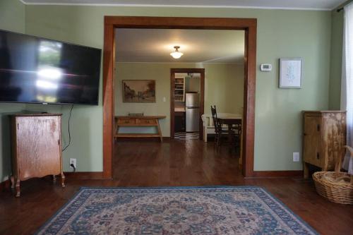 a living room with a flat screen tv and a table at 3778 East Lake Road in Dunkirk