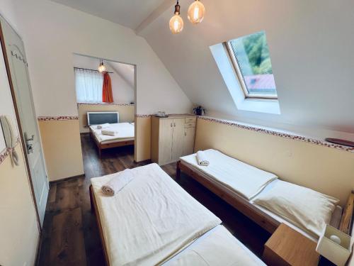 a room with two beds and a window at Privát Adriana in Kremnica