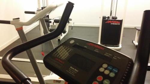 a cell phone sitting on a treadmill in a gym at First Hotel Witt in Kalmar