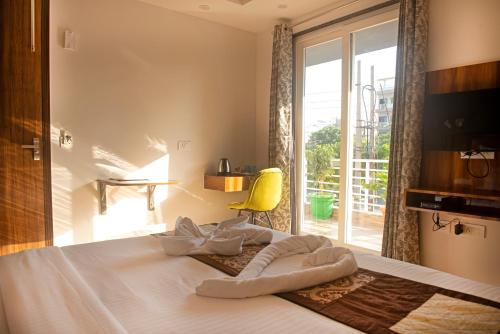 um quarto com uma cama e uma janela grande em Posh Residency Artemis Hospital Road Gurgaon em Gurgaon
