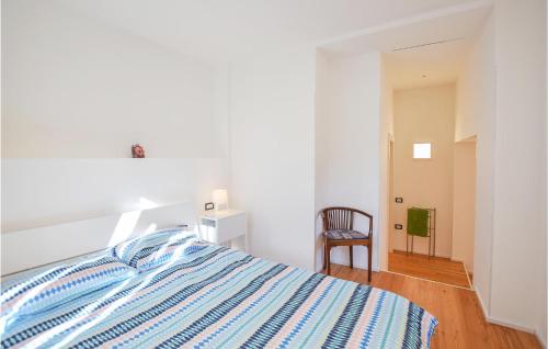 a white bedroom with a bed and a chair at Stunning Home In Ledro With Wifi in Ledro