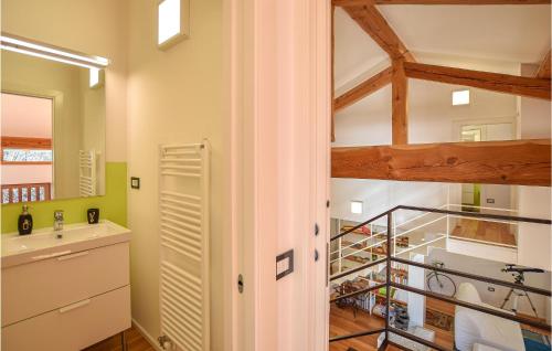 a bathroom with a sink and a staircase in a room at Stunning Home In Ledro With Wifi in Ledro
