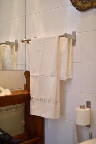 a bathroom with white towels hanging on a rack at GALLE - Suite dos Infantes in Beja