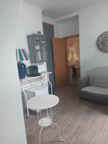 a living room with a table and a couch at GALLE - Suite dos Infantes in Beja