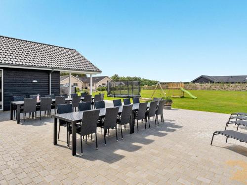 a group of tables and chairs on a patio at Luxury Retreat by Limfjorden - By Traum Ferienwohnungen in Spottrup