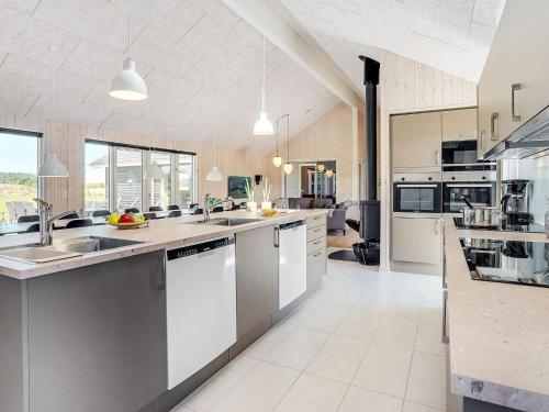 a large kitchen with white counters and appliances at Luxury Retreat by Limfjorden - By Traum Ferienwohnungen in Spottrup