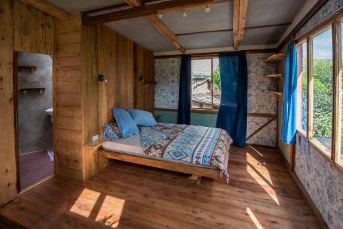 a bed in the inside of a tiny house at Avalon Hostal Boutique in Vilcabamba