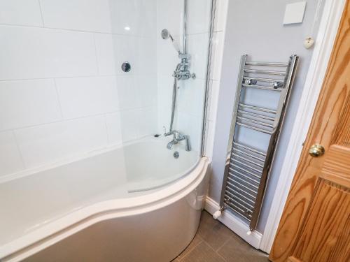 a bathroom with a shower and a bath tub at 148 Fairfield Road in Morecambe