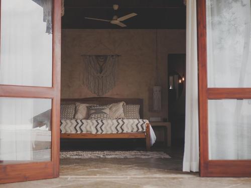 a bedroom with a bed with a ceiling fan at Vaayu Kula mandrem in Mandrem