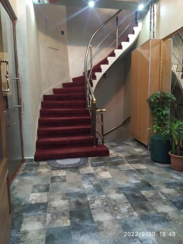 a staircase in a building with a red stair case at THE MOSS Hotel in Istanbul