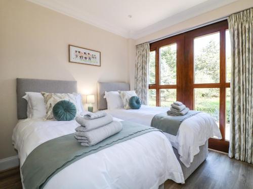 two beds in a bedroom with towels on them at Avenue Croft in Nottingham