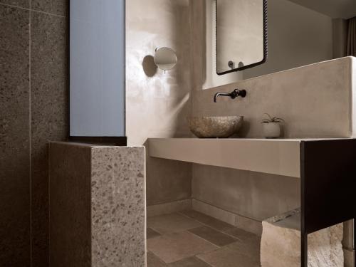 a bathroom with a sink and a mirror at Seaside A Lifestyle Resort - Adults Only in Agia Pelagia