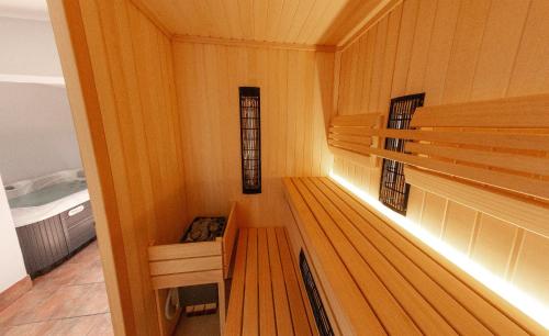 a room with a wooden bench in a sauna at Andy's Holiday Home with HotTub & Sauna in Podbočje