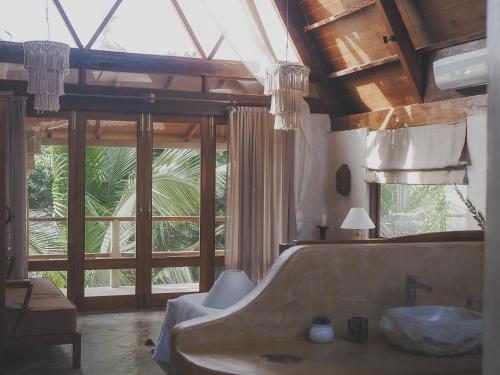 a large bathroom with a tub and a sink at Vaayu Kula mandrem in Mandrem