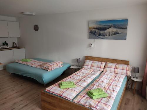 a bedroom with two beds with green pillows on them at Appartement Georg in Sankt Englmar