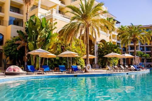a swimming pool at a hotel with chairs and umbrellas at Casa Dorada Los Cabos Resort & Spa in Cabo San Lucas