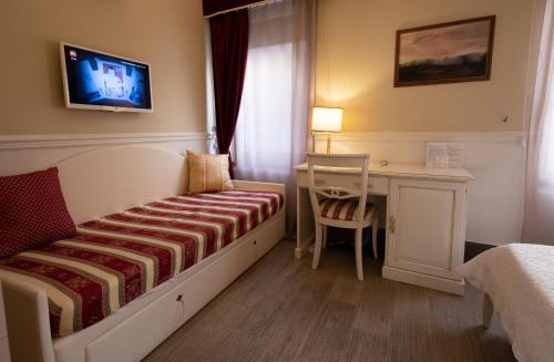 a bedroom with a bed and a desk and a tv at Bed Bra in Verona