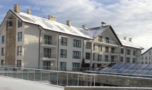 a building with solar panels on the roof at Saint George Palace Aparthotel in Bansko