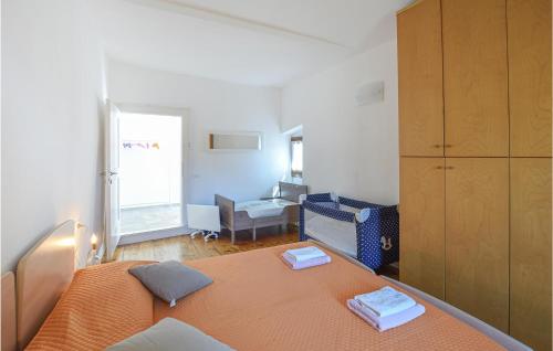 a bedroom with a bed with an orange bedspread at Stunning Apartment In Stenico With Wifi in Stenico