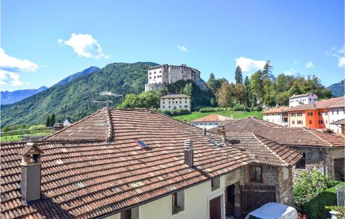a group of houses with a castle in the background at Stunning Apartment In Stenico With Wifi in Stenico