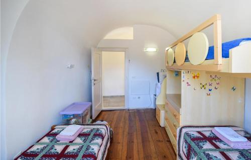 a small room with two beds and a hallway at Stunning Apartment In Stenico With Wifi in Stenico