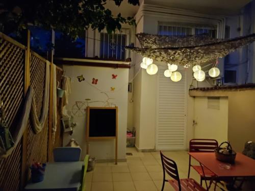 a room with a table and chairs and a television at SOTIRIA APARTMENT in Kiáton