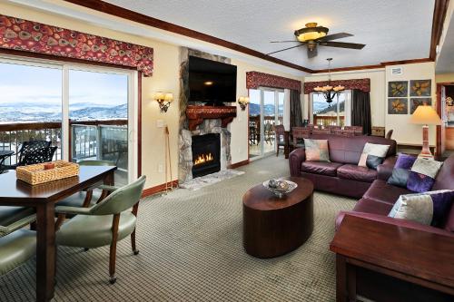a living room with a couch and a fireplace at Condos at Canyons Resort by White Pines in Park City