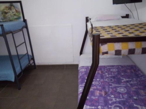 a small room with two bunk beds and a ladder at HOTEL LA REPUBLICA MANIZALES in Manizales