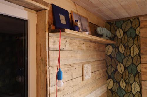 a room with a wooden wall with a blue and white object at Ennu’s hut in Loksa