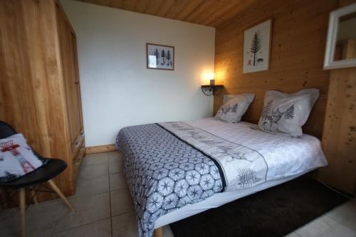 une chambre avec un lit et une chaise dedans dans l'établissement Tignes - Duplex spacieux à 2 mn des pistes - 8 pers, à Tignes