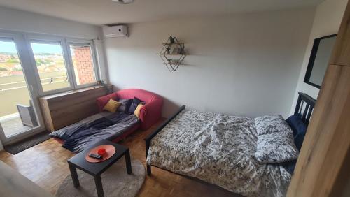 a living room with a bed and a couch at STUDIO 33 in Šabac