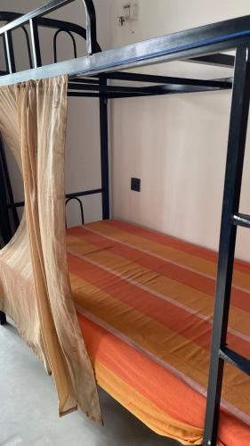 a bunk bed in a dorm room with a mattress at Sea Sands Beach Hostel in Negombo