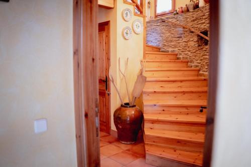 a hallway with a vase sitting next to a staircase at El Xalet de la Vall de Cardós in Lladrós