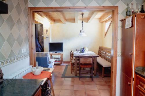 a kitchen with a table and a dining room at El Xalet de la Vall de Cardós in Lladrós