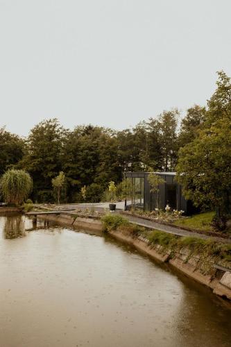 a view of a river with a building next to it at Lipa pod groniem in Ustroń