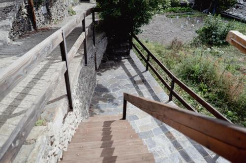a stairway leading up to a building with a railing at El Xalet de la Vall de Cardós in Lladrós