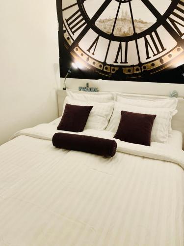 a bed with a large clock on the wall at MONI Luxury Apartments in Kopaonik
