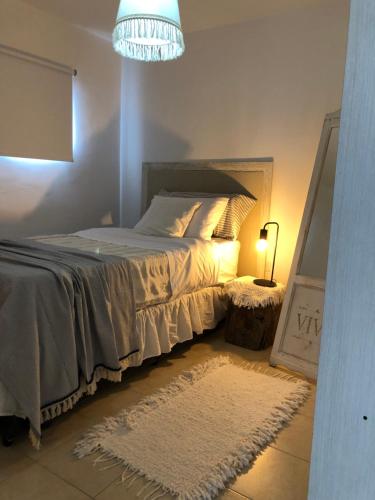 a bedroom with a bed and a chandelier at Departamento PRINGLES - con cochera in La Rioja