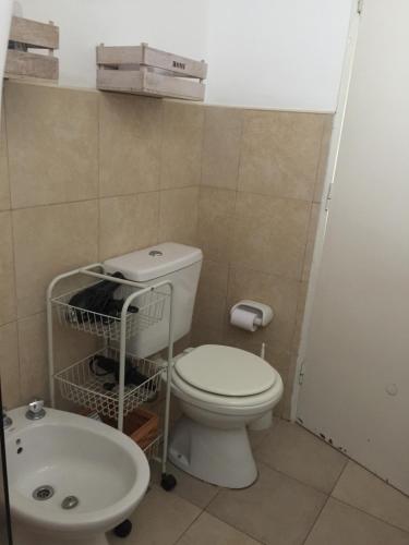 a bathroom with a toilet and a sink at Departamento PRINGLES - con cochera in La Rioja