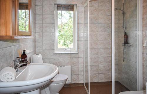 a bathroom with a sink and a toilet and a shower at Awesome Home In Klgerup With Wifi And 2 Bedrooms in Klågerup