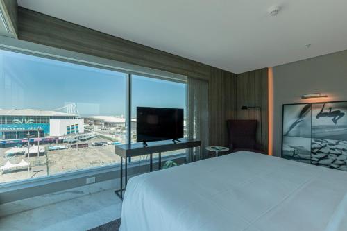a hotel room with a bed and a large window at Venit Mio Hotel in Rio de Janeiro
