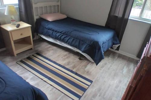 a bedroom with two beds and a night stand and a table at 2 Bedroom Condo in Rehoboth Beach w/ New Bed in Rehoboth Beach