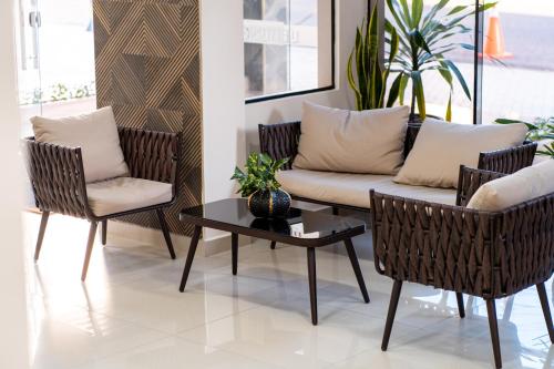 a living room with a couch and chairs and a table at Liebling Hotel Ciudad del Este in Ciudad del Este
