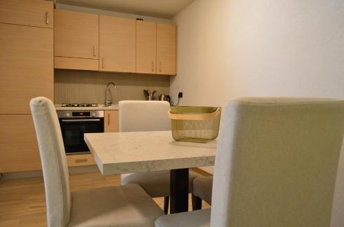 a kitchen with a table and chairs in a room at Appartamenti Sky Express in Campodolcino