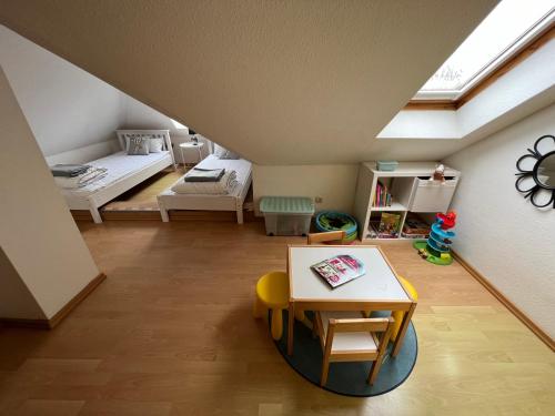 a attic room with a bed and a table at Place to be Fehmarn in Fehmarn