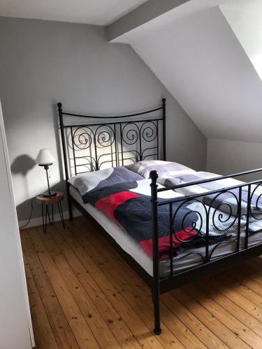 a black bed in a room with a attic at Maya's Place in Leverkusen