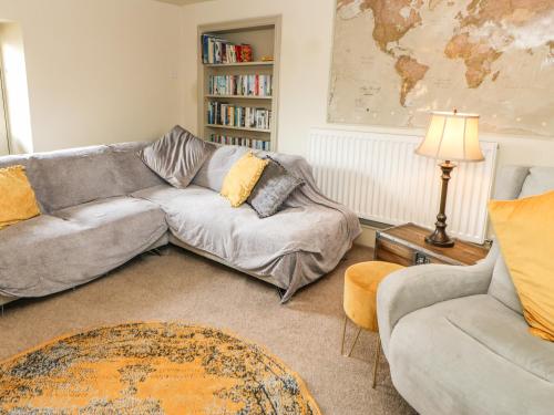 a living room with a couch and a table at Low Shipley Mill in Barnard Castle