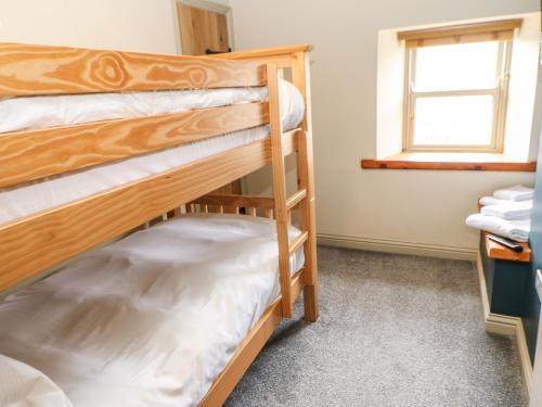 two bunk beds in a room with a window at Low Shipley Mill in Barnard Castle