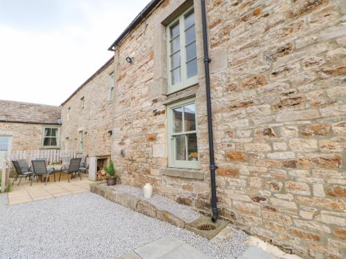 a brick building with a patio in front of it at Low Shipley Mill in Barnard Castle