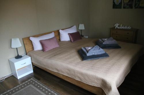 a bedroom with a large bed with two pillows on it at Ferienhaus Luci in Quedlinburg